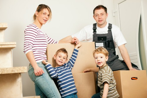 Removal team handling furniture and boxes for a Putney flat move