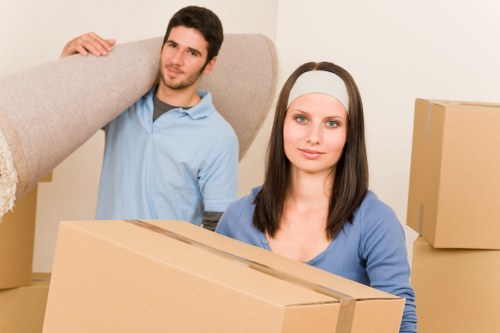 Professional team handling desks and boxes during an office move in Putney