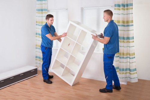 Business movers handling desks and boxes during a Putney office move