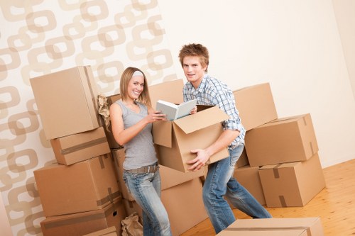 Professional movers carrying furniture in a Putney flat move