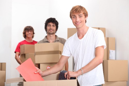 Mover carrying a boxed item during a removals service