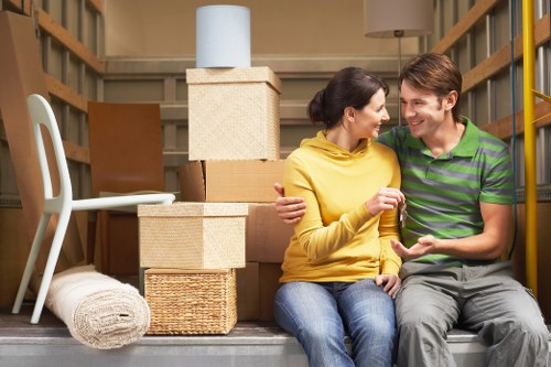 Moving team handling boxes and furniture on a Putney street